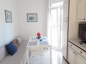 a white table in a kitchen with a window at Beautiful City Center Flat in Rhodes Town