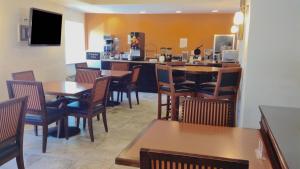 a restaurant with tables and chairs and a bar at Motel 6 Harrisburg PA Near PA Expo Center in Harrisburg