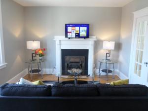 a living room with a couch and a fireplace at Bright, Clean, Private. In the Heart of Downtown! Parking, Wi-Fi and Netflix included in Ottawa