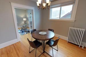 a dining room with a table and chairs and a window at Bright, Clean, Private. In the Heart of Downtown! Parking, Wi-Fi and Netflix included in Ottawa +11 photos