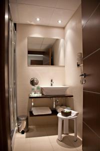 a bathroom with a sink and a mirror and a table at Estrella del Mar in Peniscola