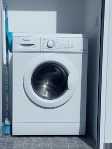 a white washing machine sitting in a room at Refúgio da Sancheira Grande in Óbidos