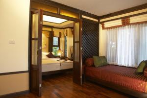 Ein Bett oder Betten in einem Zimmer der Unterkunft Salad Buri Resort- SHA Extra Plus