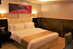 Giường trong phòng chung tại The Secure Inn Hotel Muscat