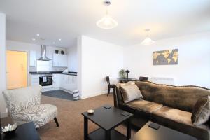 a living room with a couch and a table at Friars House, Stafford by BELL Apartments in Stafford