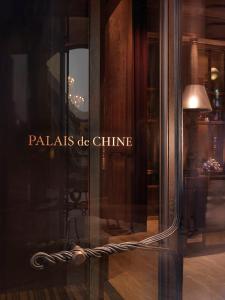 a glass window of a store with a lamp in it at Palais de Chine Hotel in Taipei