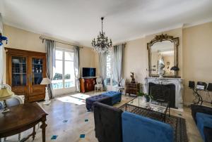 a living room with a couch and a fireplace at Villa Dracoena in Nice