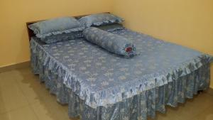 Llit o llits en una habitació de IsMa Lumut Homestay