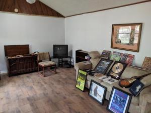a living room with a couch and a tv at The Van Zant House in Jacksonville