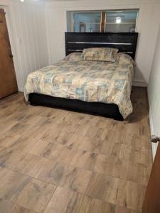 a bedroom with a bed and a wooden floor at The Van Zant House in Jacksonville