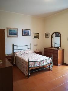 a bedroom with a bed and a dresser and a mirror at Casa vacanze Scilla in Scilla