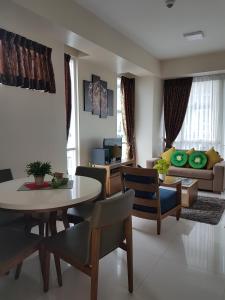 a living room with a table and a couch at Mactan Newtown Ocean View 360 Degree in Mactan