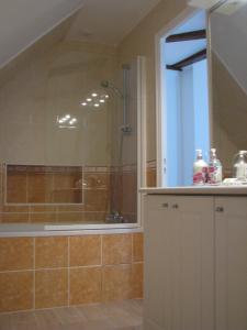 a bathroom with a shower and a sink and a tub at Alba Cottage in Bitry