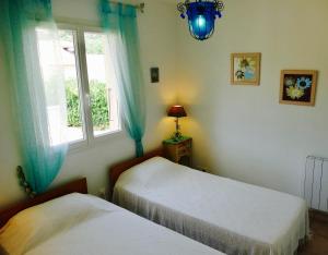 a bedroom with two beds and a window at Villa à Pinarello-2mn à pied de la plage-vue mer in Pinarellu +31 photos