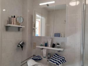 a bathroom with a shower and a sink and a mirror at Sommerwind am Kurgarten in Willingen +33 photos