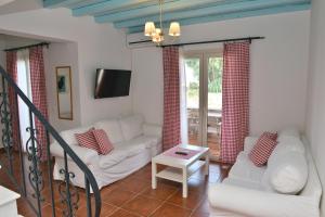 a living room with a couch and a table at Country Villas in Stelida