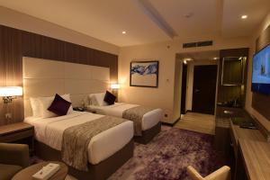 Postel nebo postele na pokoji v ubytování Paradise Elite Hotel Al-Tahlia Jeddah