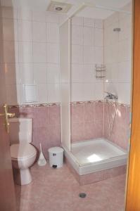 a bathroom with a toilet and a tub and a sink at Guest rooms Sveti Nikola in Pomorie