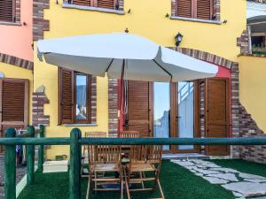 a table and chairs under a white umbrella at Villa Laura in Nebida