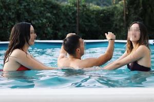 a man and two women in a swimming pool at Apartamento Rural San Jorge Bajo in Navaconcejo