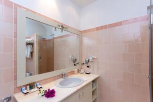 a bathroom with a sink and a mirror at Hotel Simius Playa in Villasimius