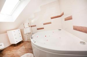 a white bathroom with a tub and a window at Penthouse Matkovic in Split