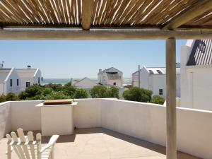 a view from the balcony of a house with a roof at Mosselbank Beach Retreat in Paternoster