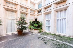 an empty building with windows and plants on the ground at LUXURY APARTMENT'S CENTER in Rome