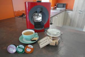 a coffee maker and a cup of coffee on a counter at Marsaskala Penthouse Apartment in Marsaskala