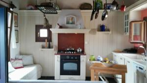 a kitchen with a stove and a couch in a room at Window To The Aegean in Velanídhia