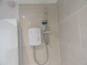 a shower in a bathroom with a soap dispenser at No 6 AT 19 IVANHOE - LARGE 2 BED NEAR SEFTON PARK AND LARK LANE in Liverpool +12 photos