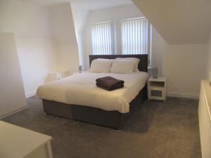 a bedroom with a large bed with two pillows at No 6 AT 19 IVANHOE - LARGE 2 BED NEAR SEFTON PARK AND LARK LANE in Liverpool