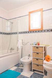 a bathroom with a white toilet and a sink at Feel-at-home in Machico in Machico