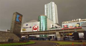 a large building with tall buildings in the background at Apartemen Startegis di Mega Kuningan in Jakarta