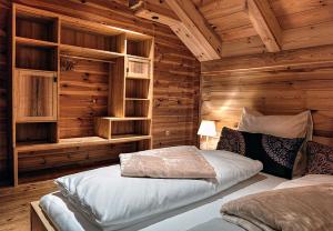 a bedroom with a bed in a wooden cabin at Chalet4You in Haus im Ennstal