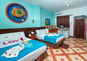 Vuode tai vuoteita majoituspaikassa Hotel Coloma Galapagos