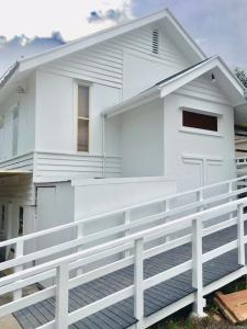 a white house with a white fence in front of it at Parkview Brisbane in Brisbane