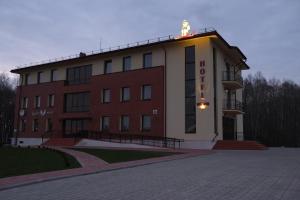 a building with a sign on top of it at Hotel Angelas in Utena