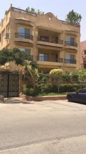 a building with a car parked in front of it at A studio / private room in New Cairo in Cairo