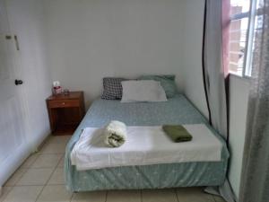 a bedroom with a bed with a stuffed animal on it at Casa Blanca Tu Casa in Santa Ana