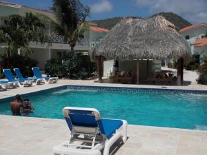 a man is in the swimming pool at a resort at Bon Bini Lagun Curacao in Lagun