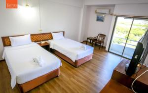 Postel nebo postele na pokoji v ubytování Wiangwalee Hotel