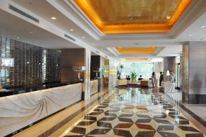 a lobby of a hotel with a tiled floor at Monarch Skyline Hotel in Luzhu