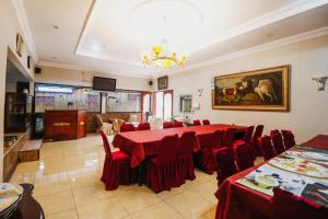 a dining room with a red table and chairs at RedDoorz @ Cibogo Puncak Bogor in Bogor