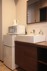 a kitchen with a sink and a microwave at Tanimachi 4chome 5F in Osaka