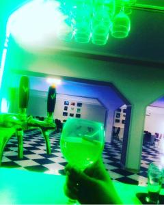 a person holding a wine glass on a table at Керуен сарайы, гостиница in Aralʼsk