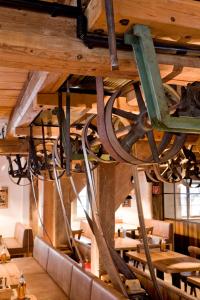 a restaurant with a wooden ceiling with tables and chairs at Hotel Kunstmühle in Mindelheim