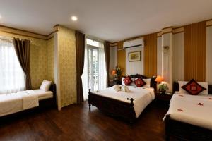 a hotel room with two beds and a window at Hanoi Marriotte Hotel in Hanoi