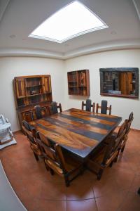 a dining room with a large wooden table and chairs at The Sweetest Spot in St Lucia