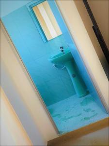 a bathroom with a blue sink in a room at Samanala Resort in Matara